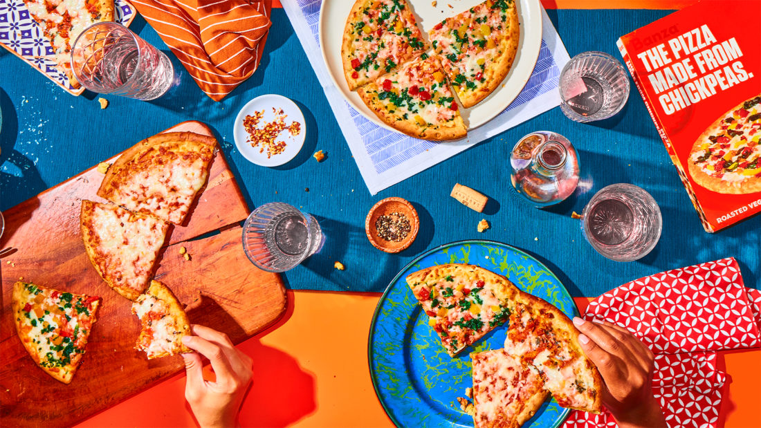 An aerial view of a picnic featuring Banza chickpea pizza crust.