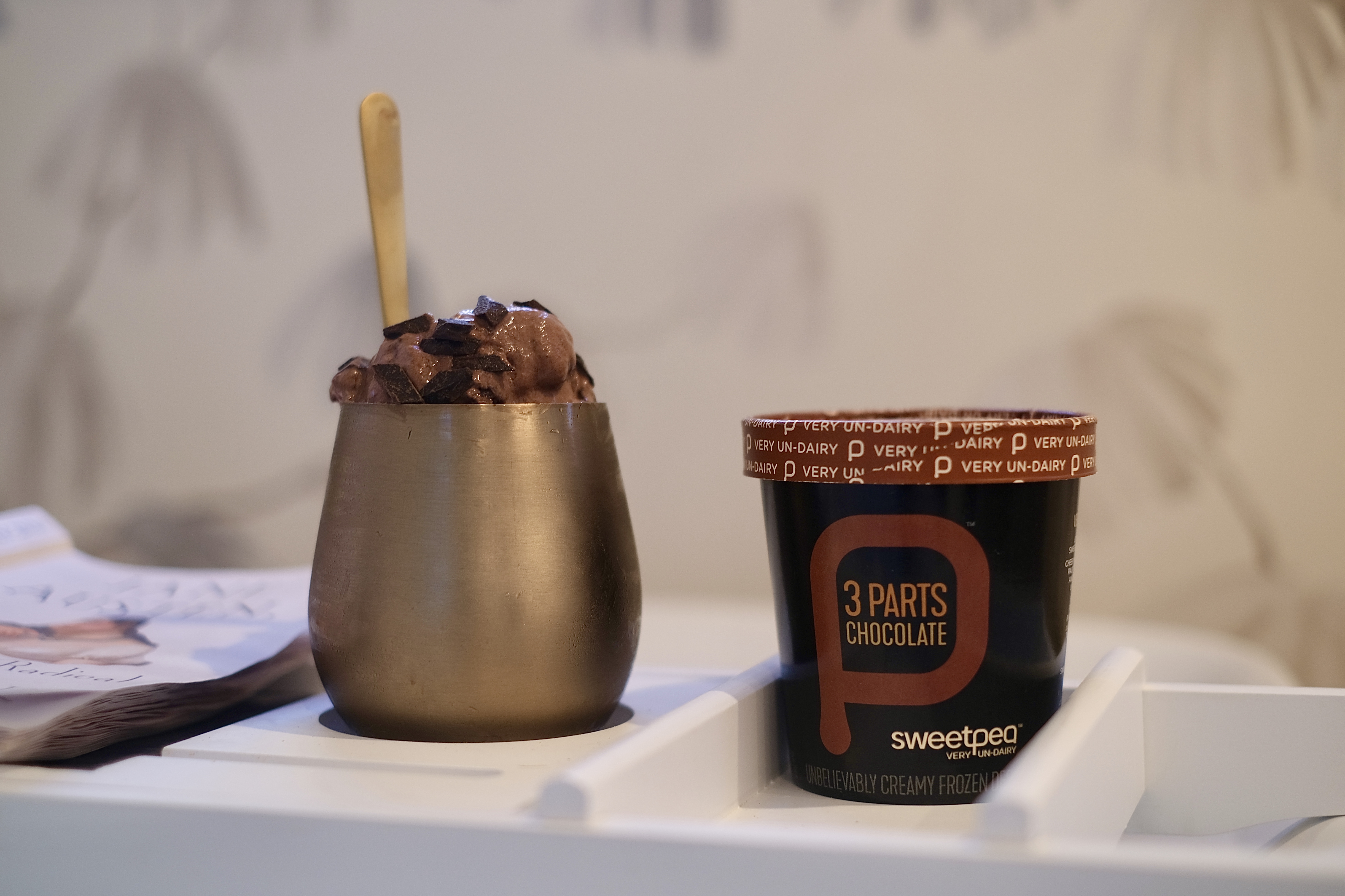 A photo showing a pint of 3 Parts Chocolate on the right and a bronze stemless wine cup filled with 3 Parts Chocolate.